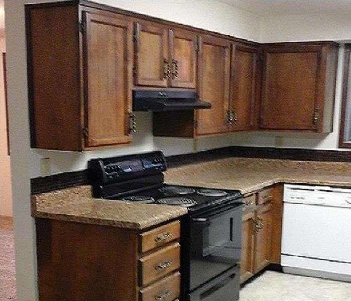 Kitchen stove and surrounding cabinets restored to normal