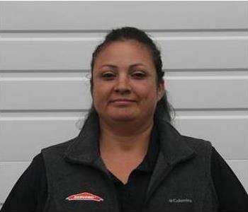 Female employee with white garage door background