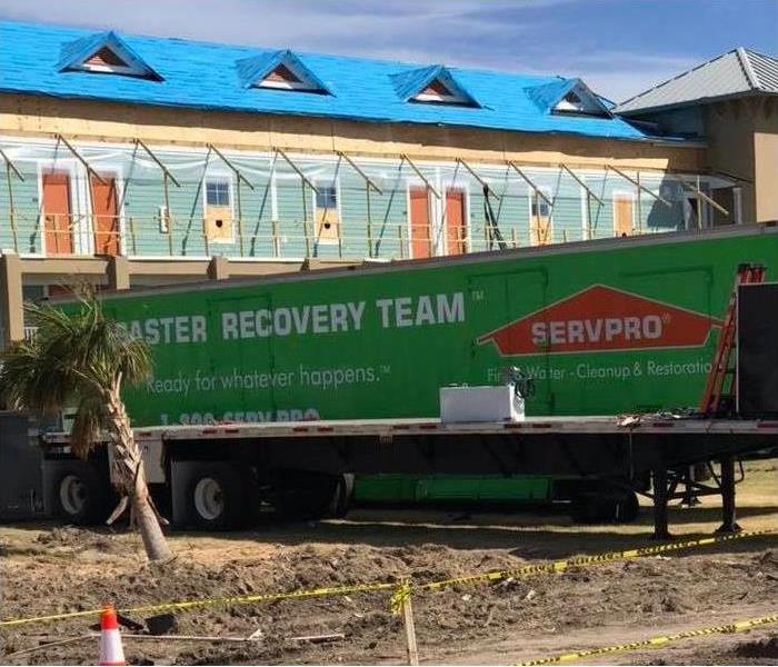 Servpro Semi Truck Trailer Parked Next to Large Commercial Building